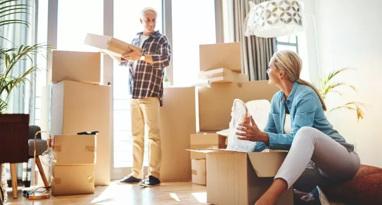 older couple unpacking boxes in a well-lit room